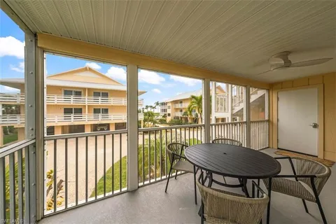 a view of a balcony with table and chairs