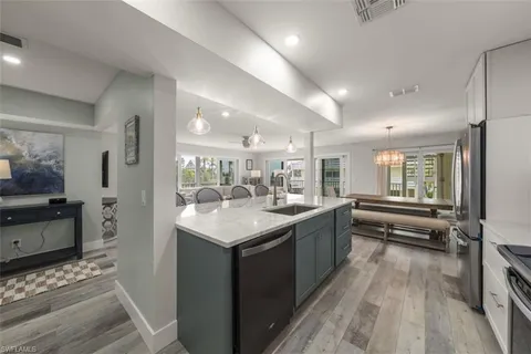 a large kitchen with kitchen island granite countertop a large counter top and sink