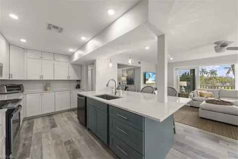 a large white kitchen with a large window