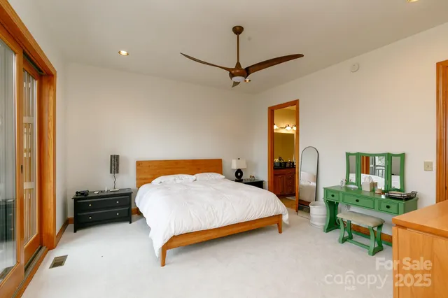 a bedroom with a bed a table and painting