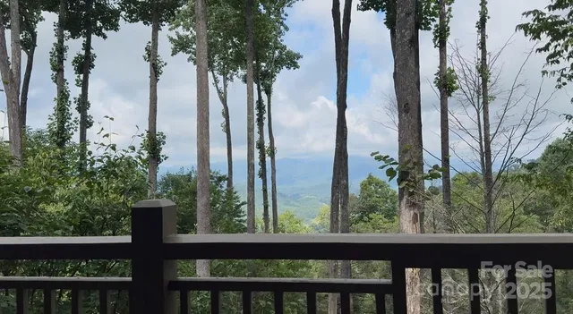 a view of a wooden fence and trees