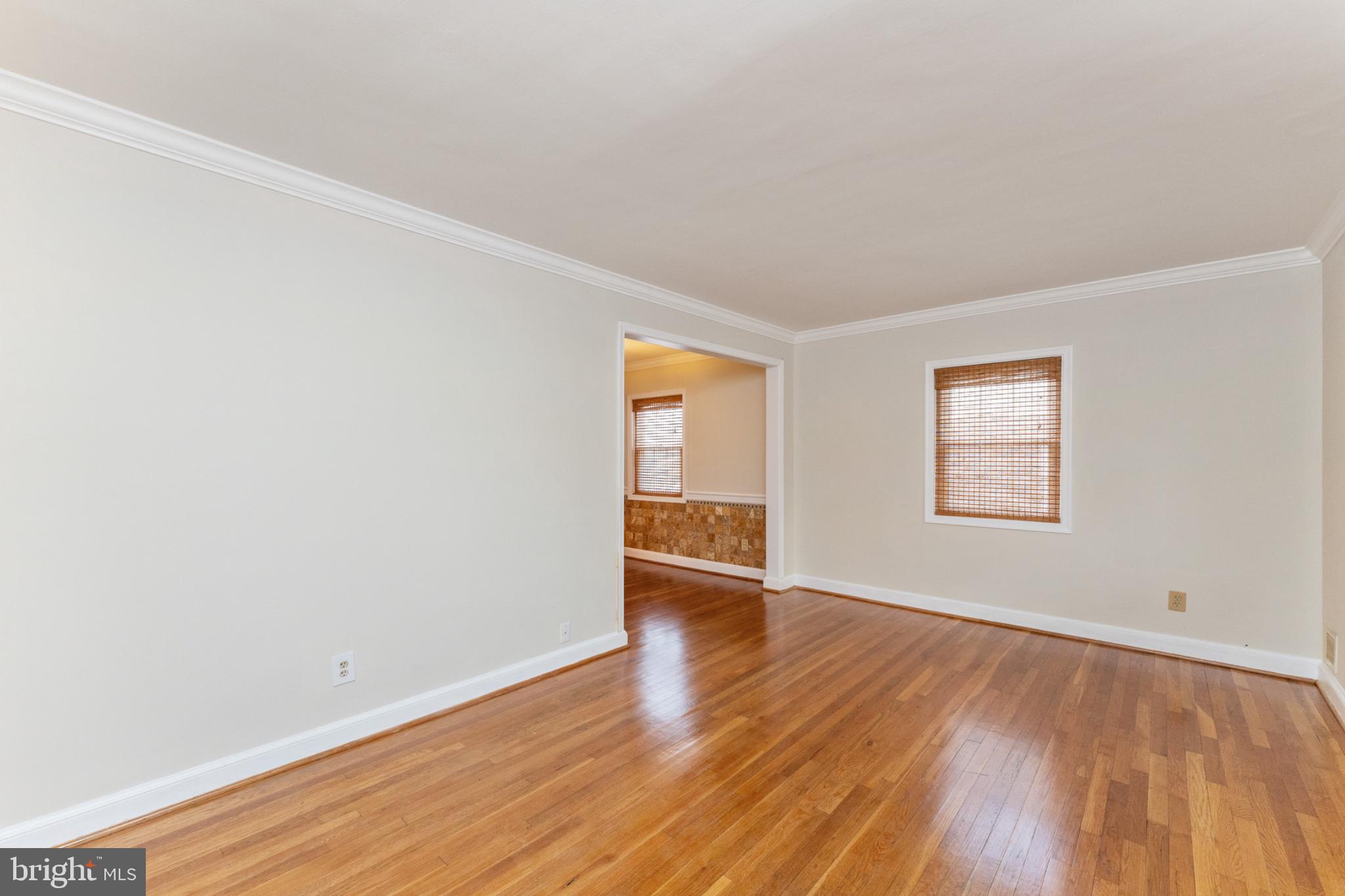 1609 Brisbane Street Silver Spring, MD 20902 - Photo 20 of 24 an empty room with wooden floor and windows