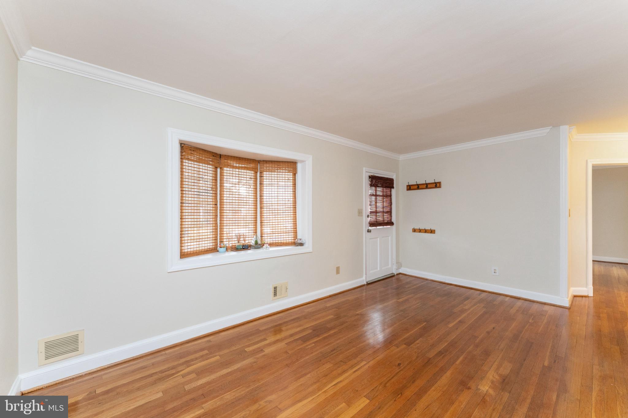 1609 Brisbane Street Silver Spring, MD 20902 - Photo 5 of 24 an empty room with wooden floor and windows