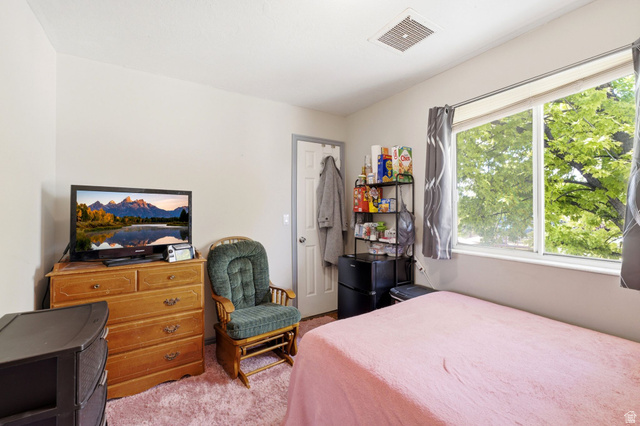 2475 Church Street Layton, UT 84040 - Photo 20 of 27 Light-filled interior space featuring a large window, neutral wall paint, and a white ceiling with a central vent