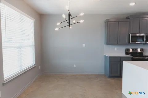 a kitchen with kitchen island a sink stainless steel appliances and cabinets
