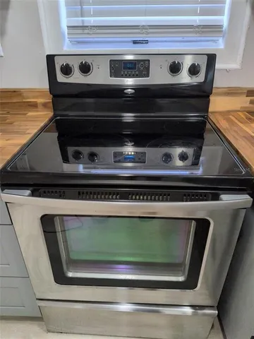 a stove top oven sitting inside of a kitchen