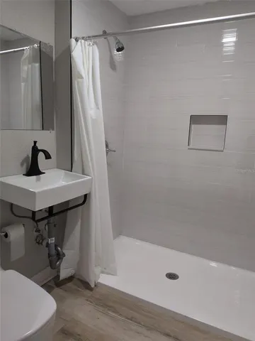 a bathroom with a sink a mirror and a shower