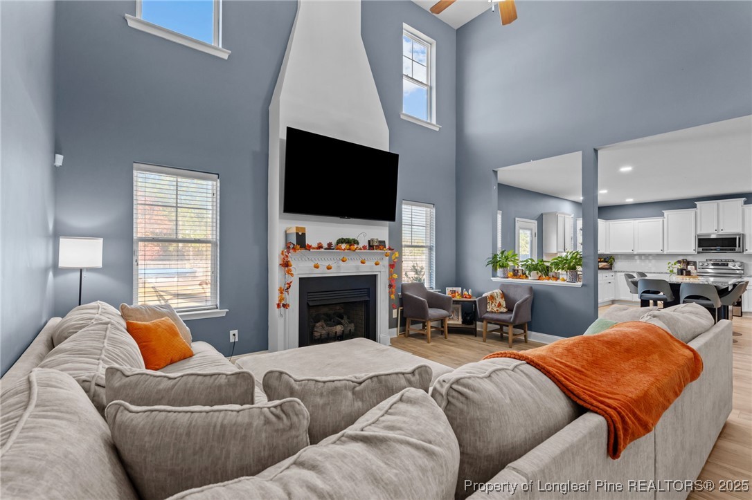 240 Heathrow Drive Spring Lake, NC 28390 - Photo 11 of 47 a living room with furniture a fireplace and a flat screen tv