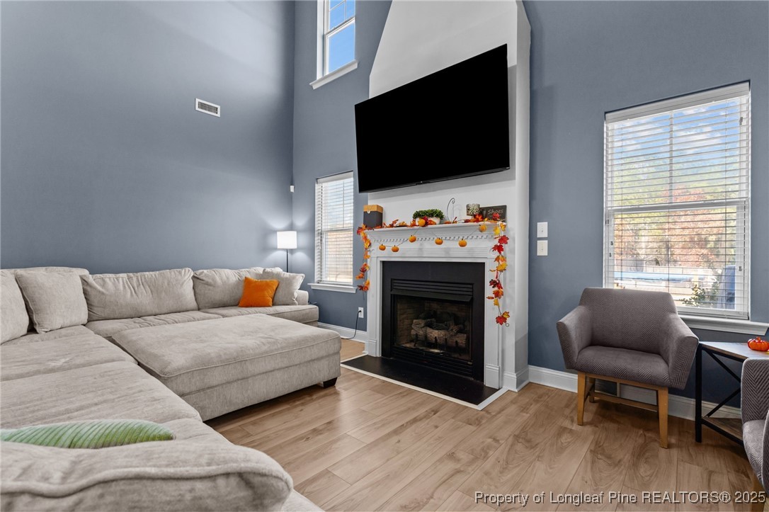 240 Heathrow Drive Spring Lake, NC 28390 - Photo 12 of 47 a living room with furniture a flat screen tv and a fireplace