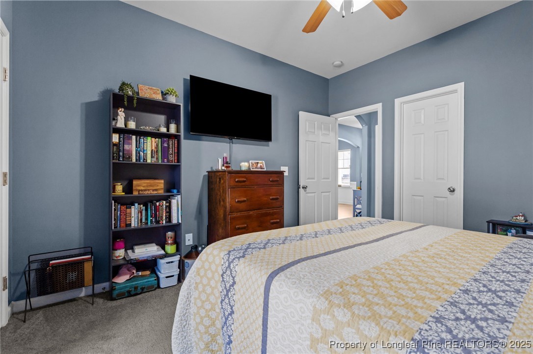 240 Heathrow Drive Spring Lake, NC 28390 - Photo 19 of 47 a bedroom with a bed and a flat screen tv