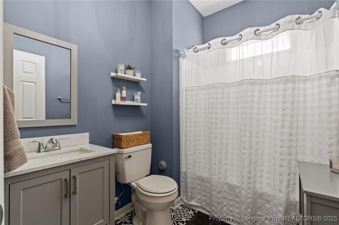 240 Heathrow Drive Spring Lake, NC 28390 - Photo 20 of 47 a bathroom with a sink toilet and vanity
