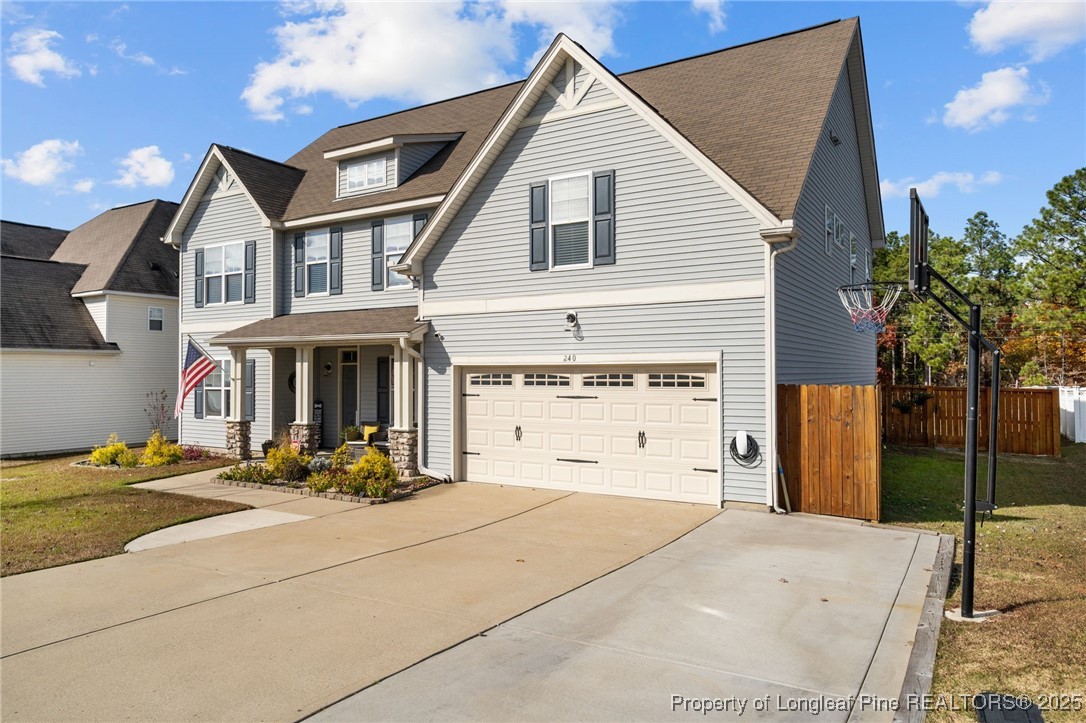 240 Heathrow Drive Spring Lake, NC 28390 - Photo 2 of 47 a view of a house with potted plants and floor to ceiling window