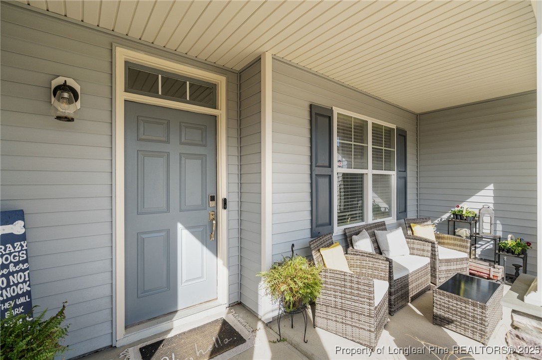 240 Heathrow Drive Spring Lake, NC 28390 - Photo 3 of 47 a front view of a house with outdoor seating and windows