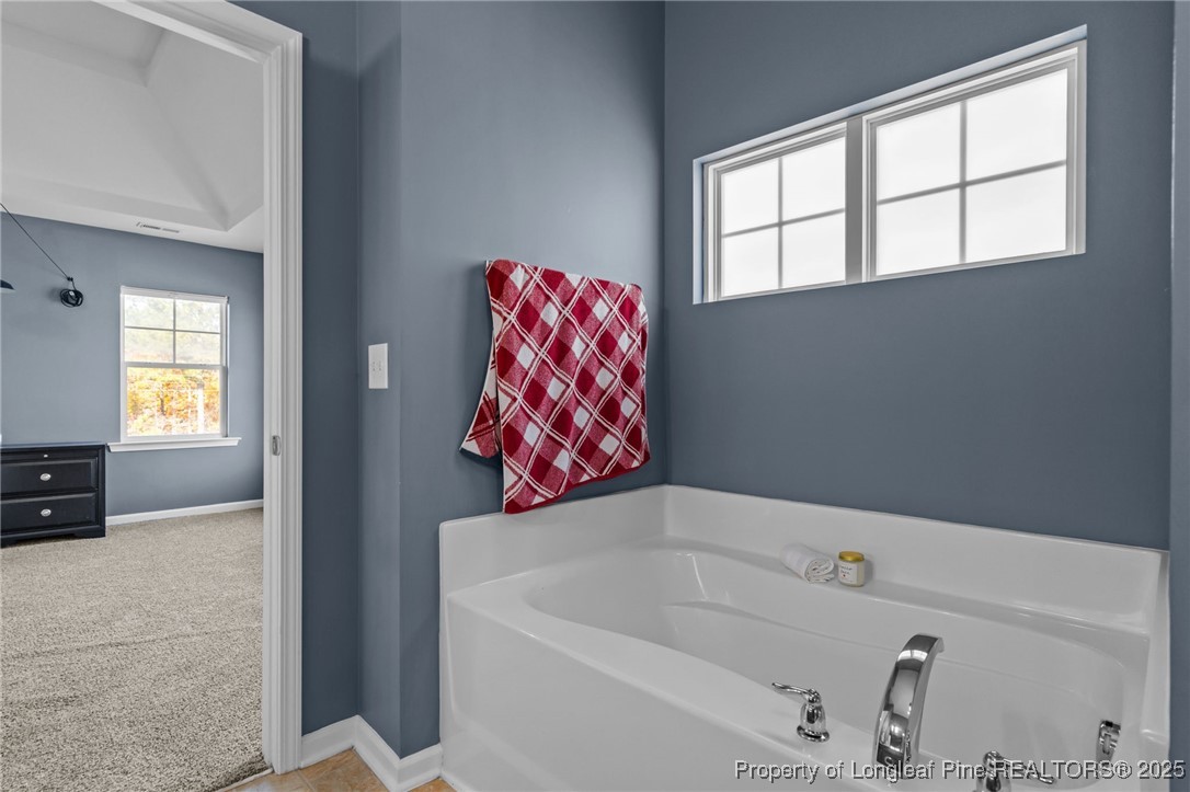 240 Heathrow Drive Spring Lake, NC 28390 - Photo 31 of 47 a bathroom with a bathtub and a shower