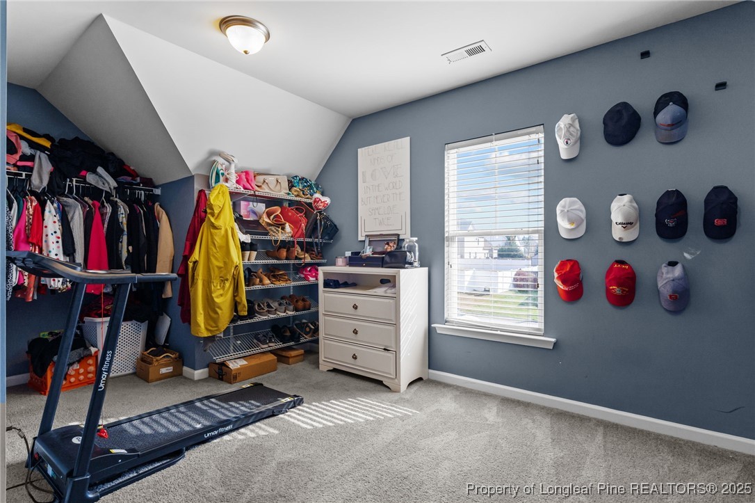 240 Heathrow Drive Spring Lake, NC 28390 - Photo 32 of 47 a view of walk in closet with clothes and shoes