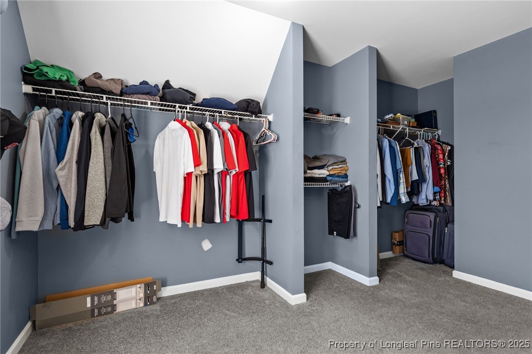 240 Heathrow Drive Spring Lake, NC 28390 - Photo 33 of 47 a view of walk in closet with clothes