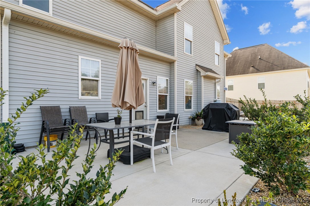 240 Heathrow Drive Spring Lake, NC 28390 - Photo 39 of 47 a view of a patio with couches table and chairs and potted plants