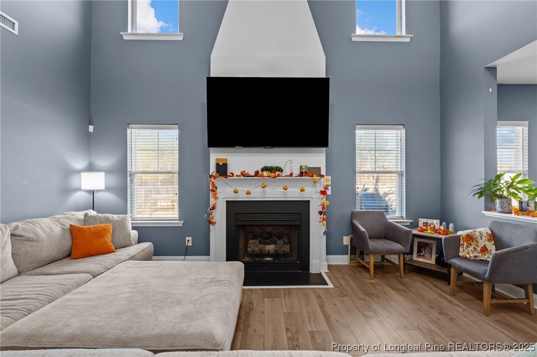 240 Heathrow Drive Spring Lake, NC 28390 - Photo 10 of 47 a living room with furniture a flat screen tv and a fireplace