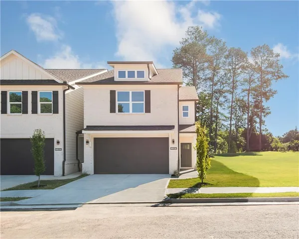 a front view of a house with a yard and garage