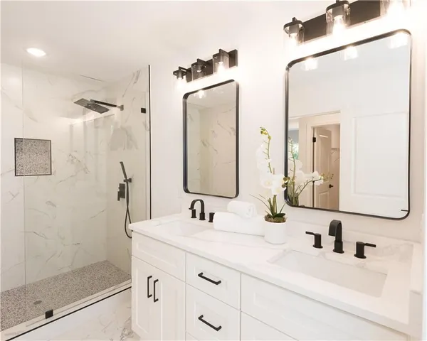 a bathroom with a shower sink and mirror