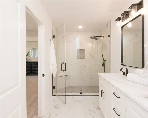 a bedroom with a large bed and a ceiling fan