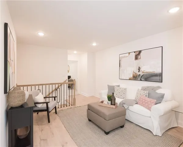 a living room with furniture and a wooden floor