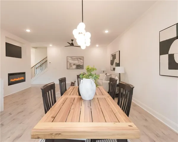 a kitchen with stainless steel appliances white cabinets and a refrigerator