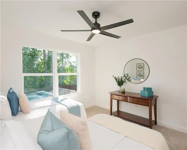 a bedroom with a large bed and a window