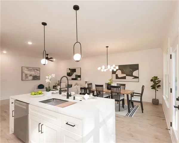 a kitchen with a dining table chairs and white cabinets