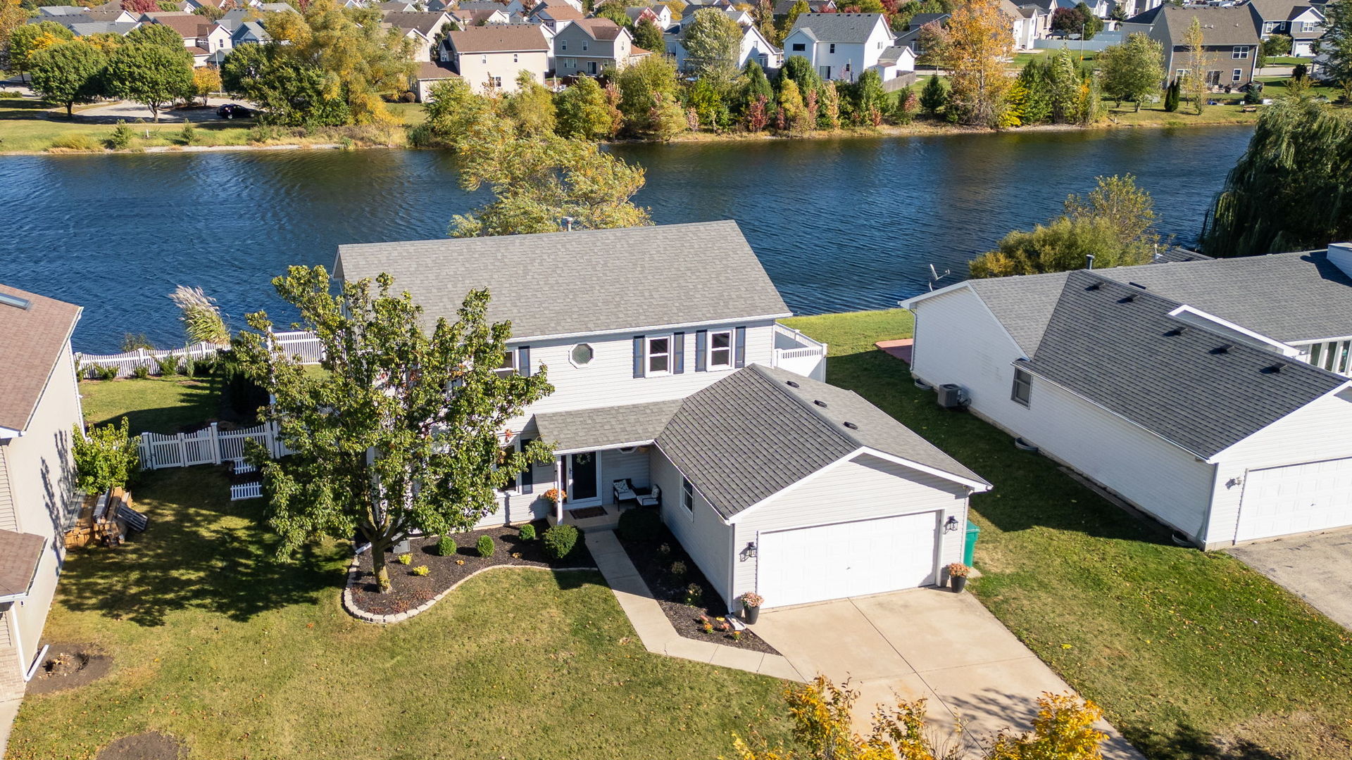 an aerial view of a house with a lake view