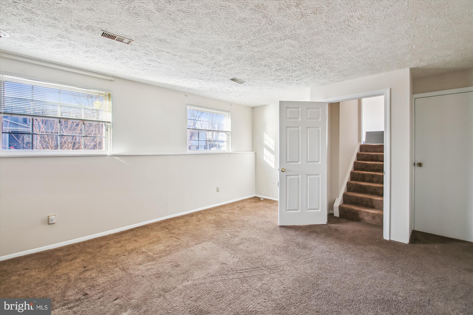 1474 Gesna Drive Hanover, MD 21076 - Photo 19 of 39 an empty room with a staircase and white walls