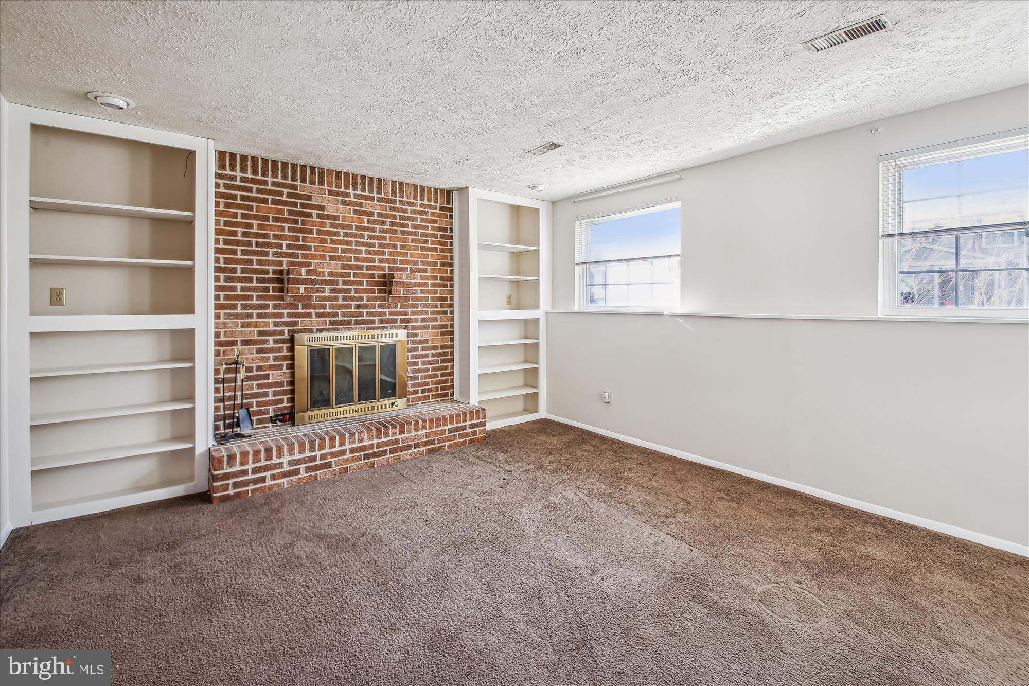 1474 Gesna Drive Hanover, MD 21076 - Photo 20 of 39 a view of an empty room with a fireplace and a window