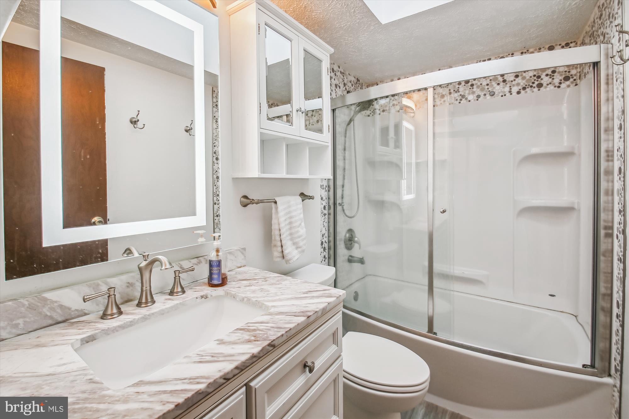 1474 Gesna Drive Hanover, MD 21076 - Photo 31 of 39 a bathroom with a granite countertop sink toilet and shower