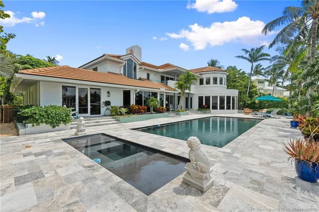 a front view of a house with yard and green space