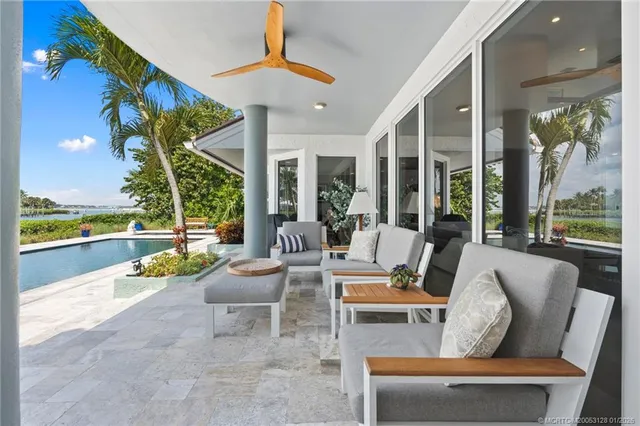 a living room with furniture and large windows