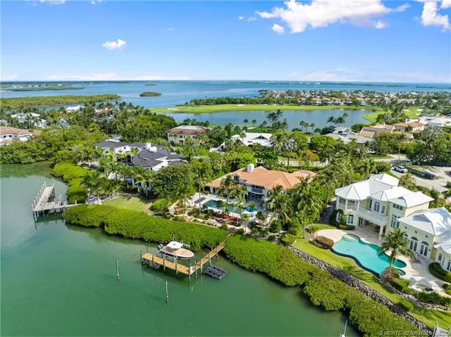 an aerial view of a house with a yard swimming pool and outdoor seating