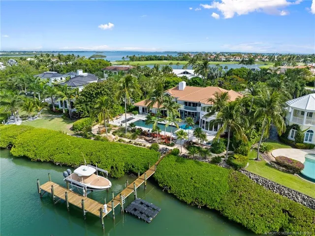 a front view of a house with swimming pool having outdoor seating