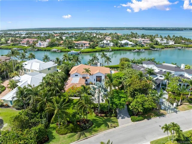 a view of a patio with a table and chairs under an umbrella