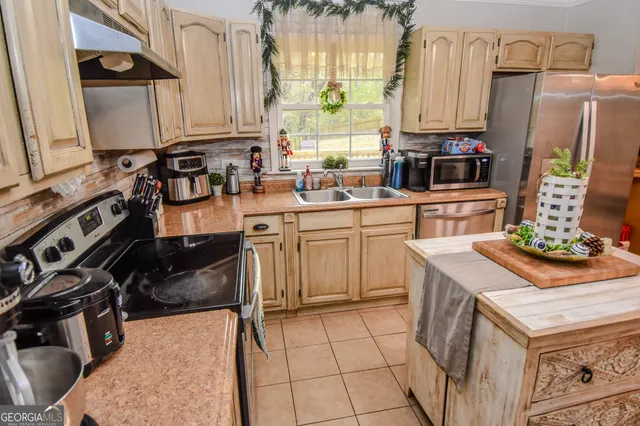 a kitchen with a sink stove and refrigerator