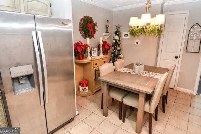 a view of a dining room with furniture and chandelier