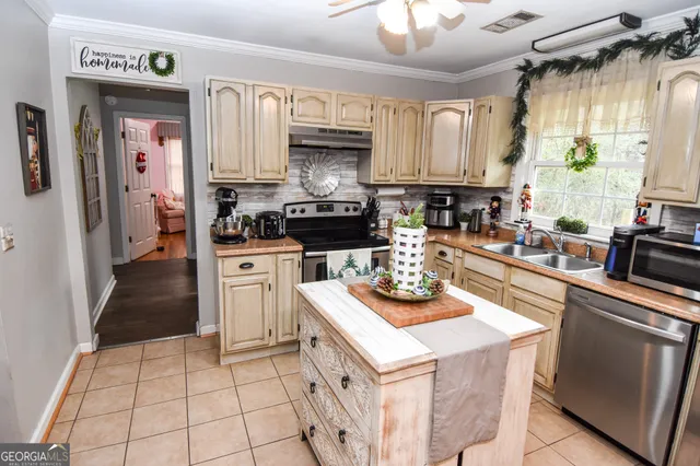 a kitchen with a sink a stove and cabinets