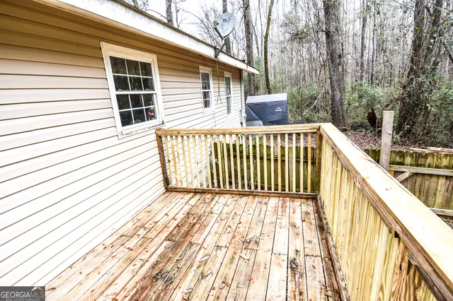 a view of a balcony with wooden floor and fence