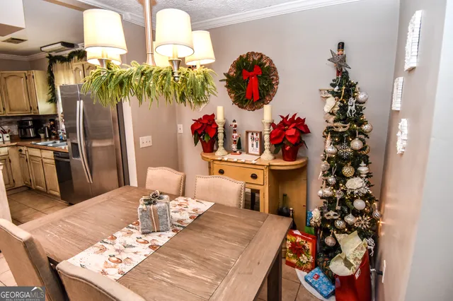 a living room with stainless steel appliances furniture and a rug
