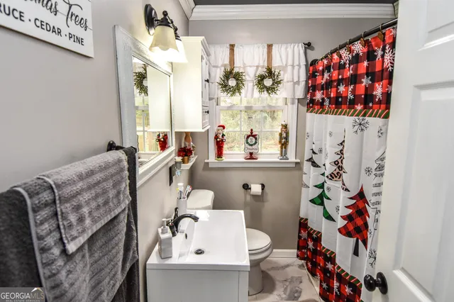 a bathroom with a sink and mirror with bathtub