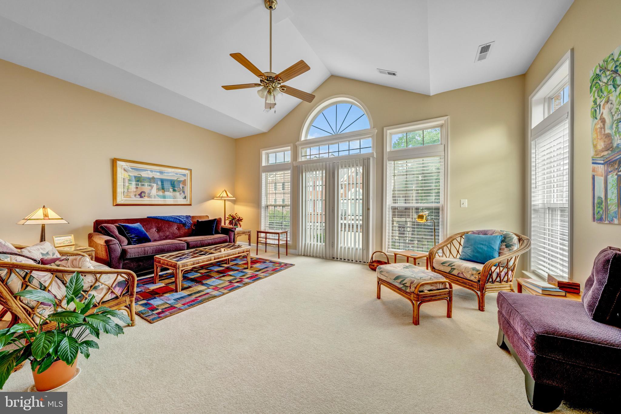1925 Logan Manor Drive Reston, VA 20190 - Photo 21 of 61 a living room with furniture a chandelier and a floor to ceiling window