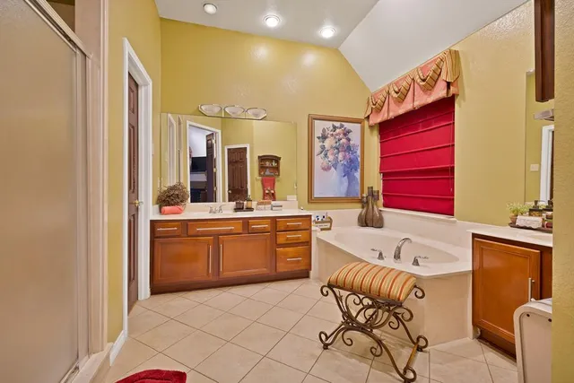 a bathroom with a bathtub sink and mirror