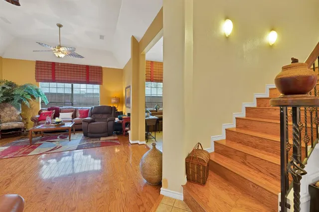 a living room with furniture a couch and potted plants