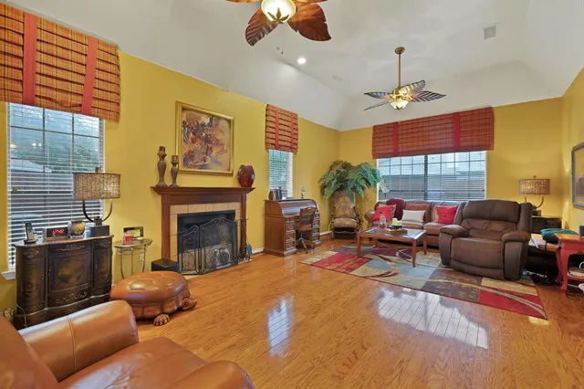 a living room with furniture fireplace and flat screen tv