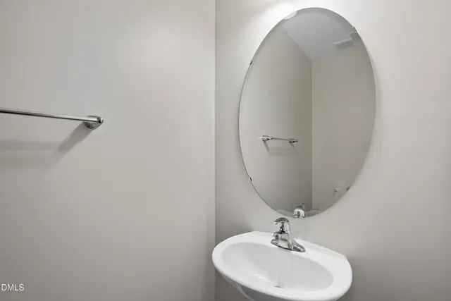 a bathroom with a sink and mirror