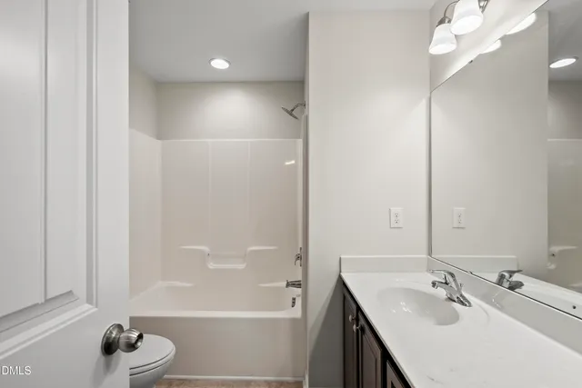 a bathroom with a bathtub a sink and a mirror